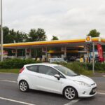 Archive photograph of a Shell petrol station in Haydock, England, in July 2021; prices shown are historical, not current fuel prices.