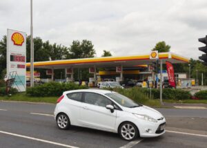Archive photograph of a Shell petrol station in Haydock, England, in July 2021; prices shown are historical, not current fuel prices.